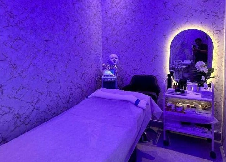 Luxurious spa treatment room at M&M Gents Salon, Dubai, Dubai, AE with ambient blue lighting and modern decor.