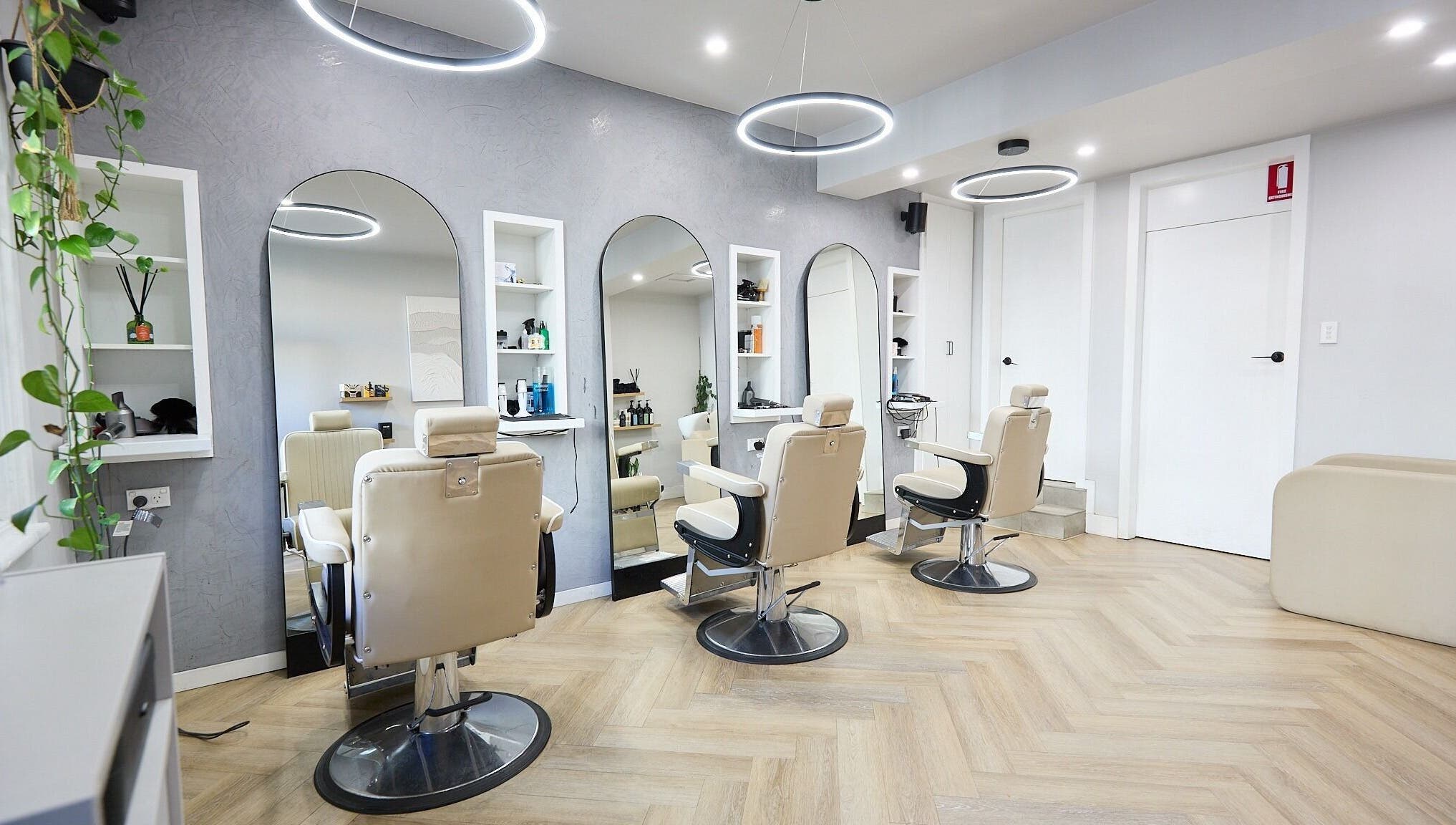 Interior of Verve Barbering - Surry Hills with stylish chairs and wall mirrors in Surry Hills, New South Wales, AU.