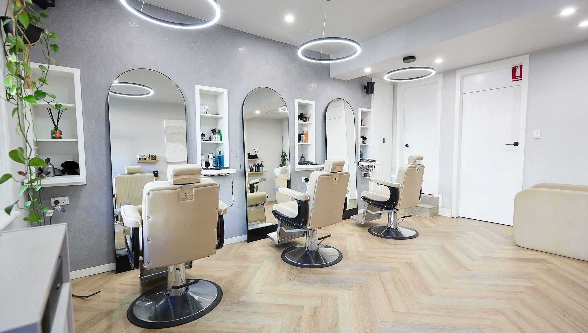Interior of Verve Barbering - Surry Hills with stylish chairs and wall mirrors in Surry Hills, New South Wales, AU.
