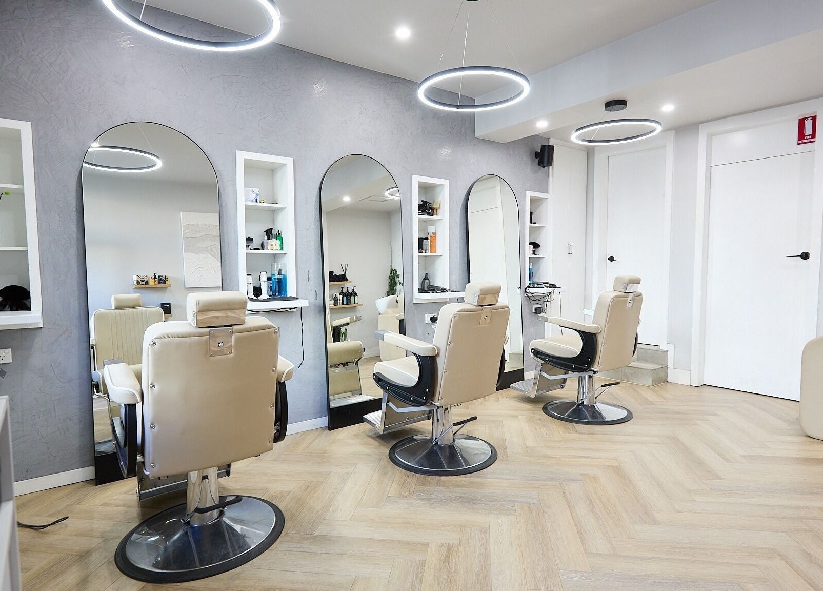 Interior of Verve Barbering - Surry Hills with stylish chairs and wall mirrors in Surry Hills, New South Wales, AU.
