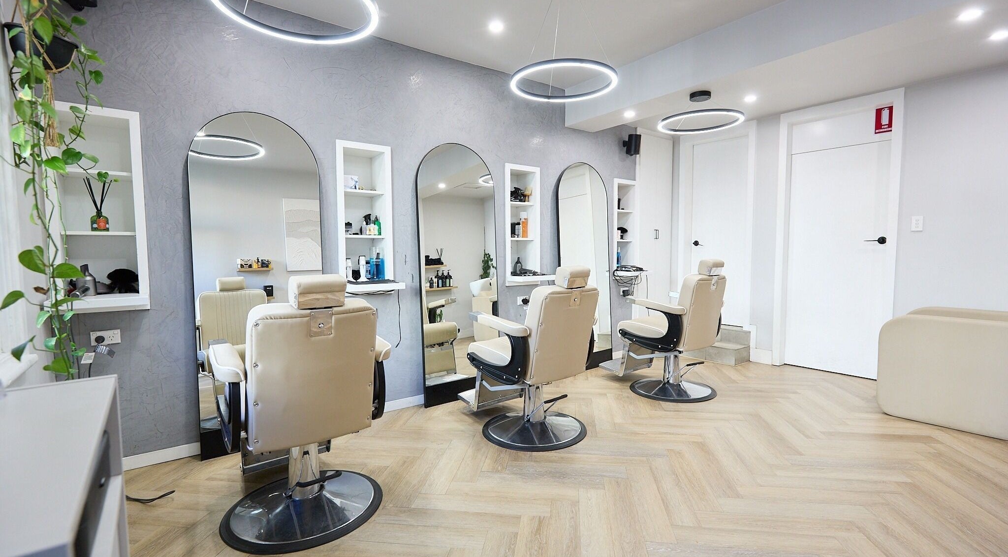 Interior of Verve Barbering - Surry Hills with stylish chairs and wall mirrors in Surry Hills, New South Wales, AU.