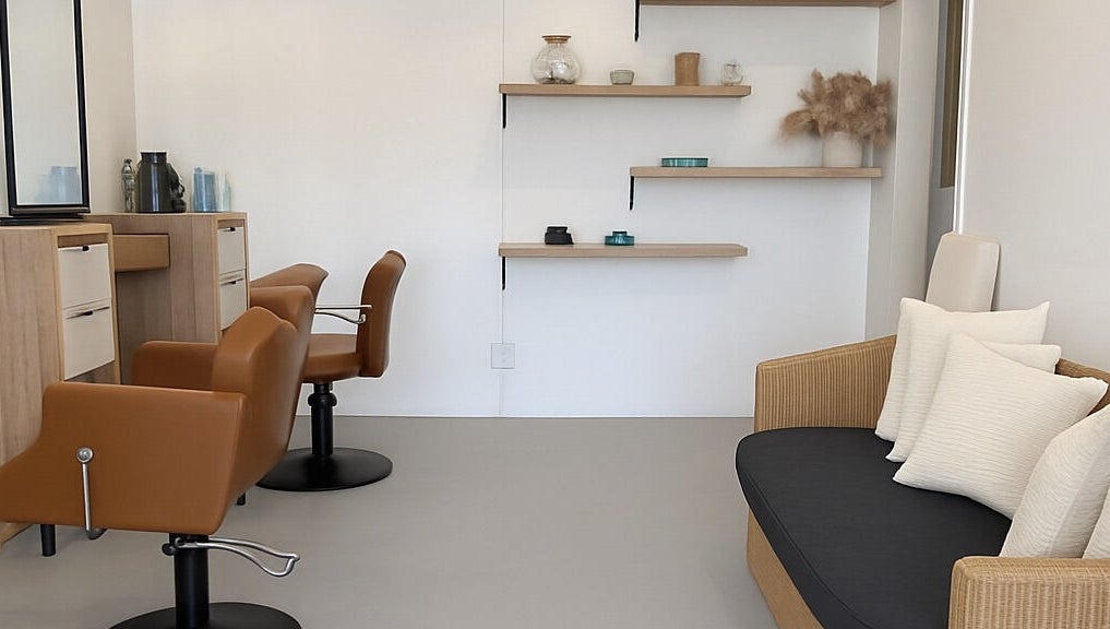 Modern salon interior at morelli in Bridgetown, Saint Michael, BB with stylish chairs and shelving.