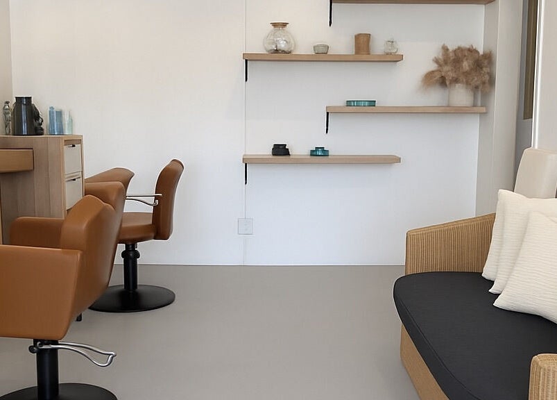 Modern salon interior at morelli in Bridgetown, Saint Michael, BB with stylish chairs and shelving.