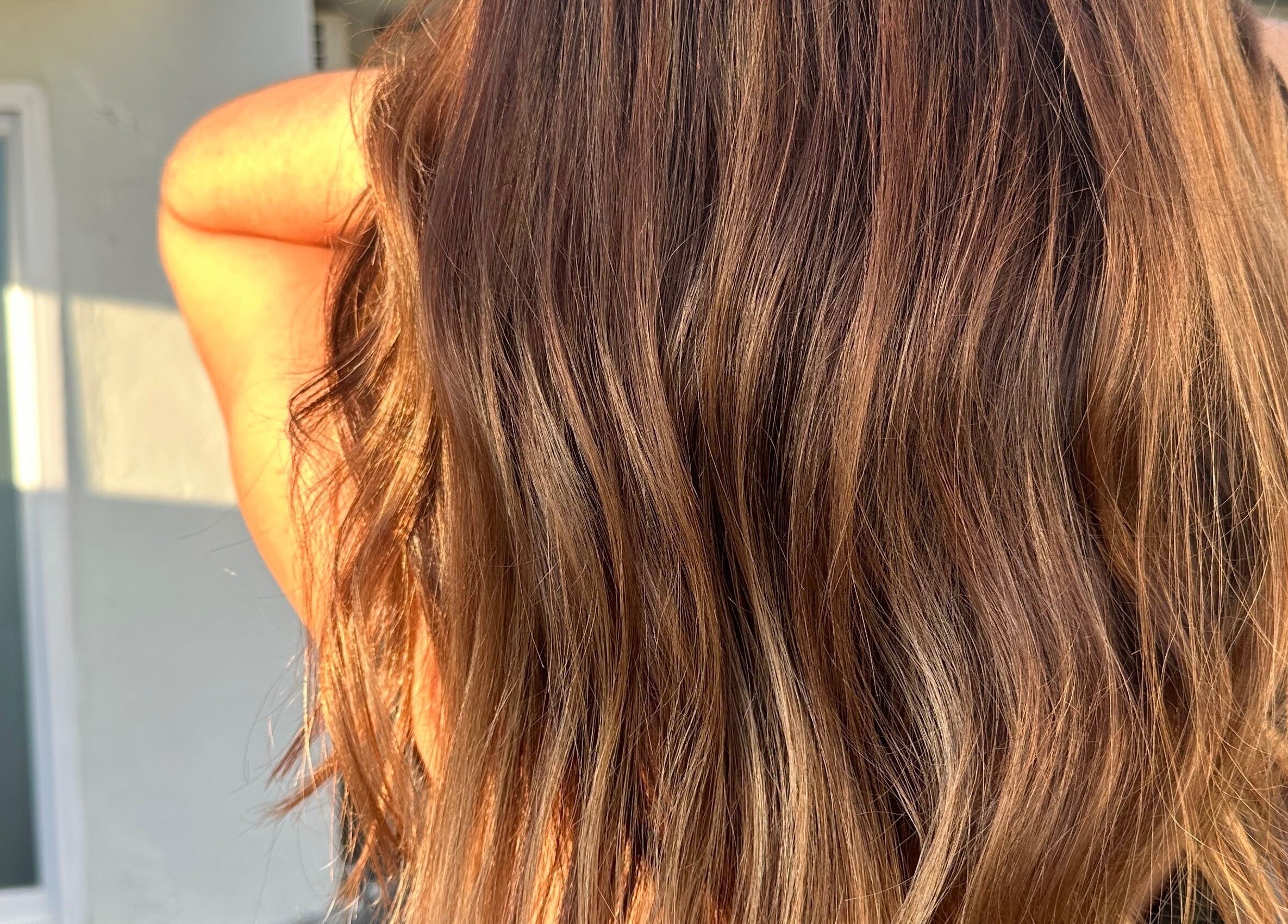 Flowing golden hair at morelli., Bridgetown, Saint Michael, BB, bathed in sunlight.