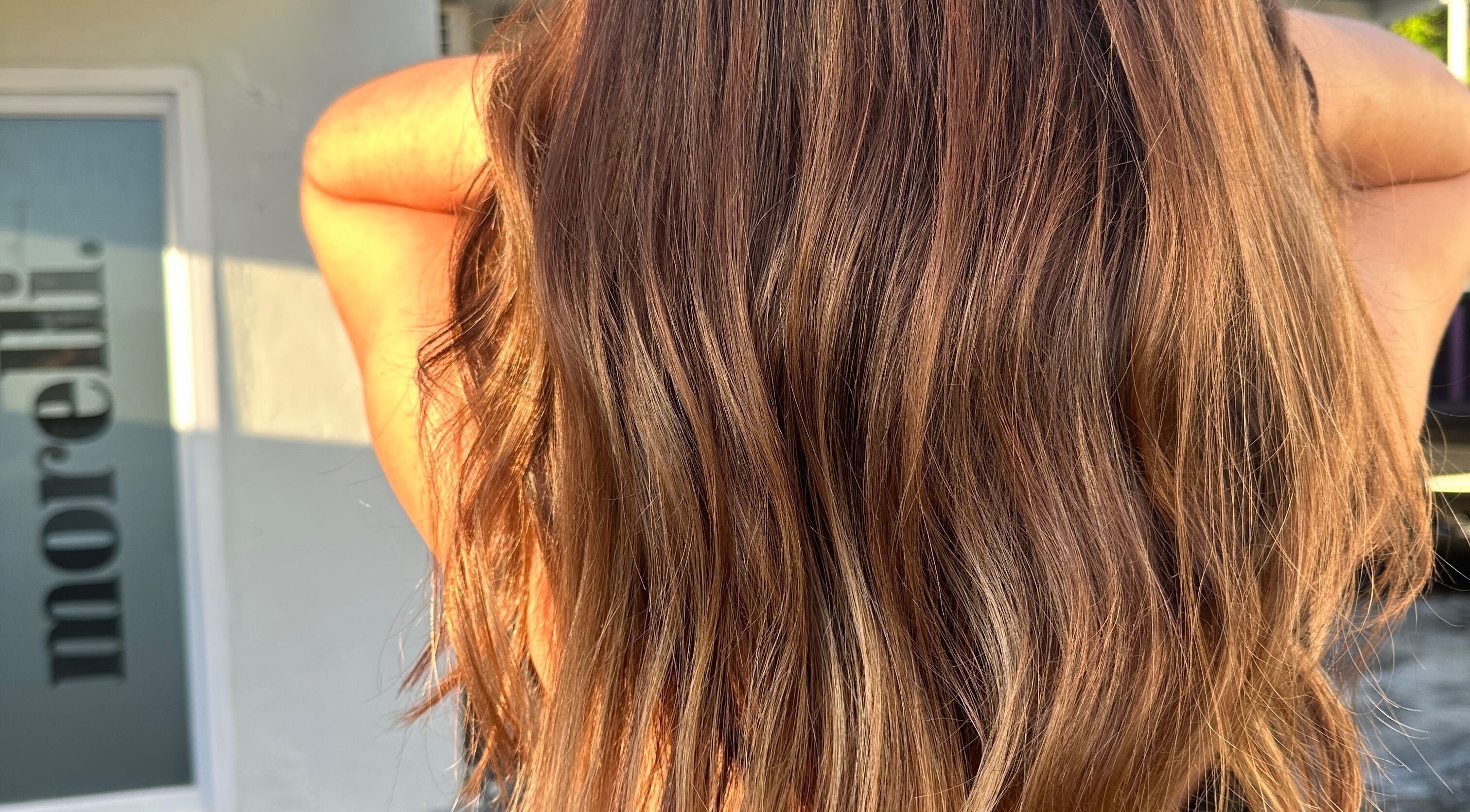 Flowing golden hair at morelli., Bridgetown, Saint Michael, BB, bathed in sunlight.