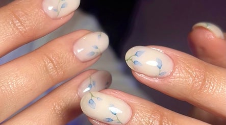 Elegant nail art with blue floral design at MKM Beauty, Lancaster, England, GB.