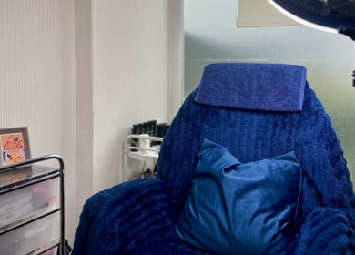 Cozy blue treatment chair at MKM Beauty in Lancaster, England, GB, offering a relaxing wellness experience.