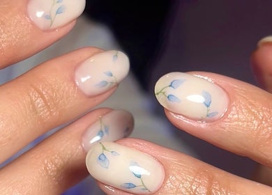 Elegant floral nail art at MKM Beauty in Lancaster, England, GB, showcasing delicate blue designs.