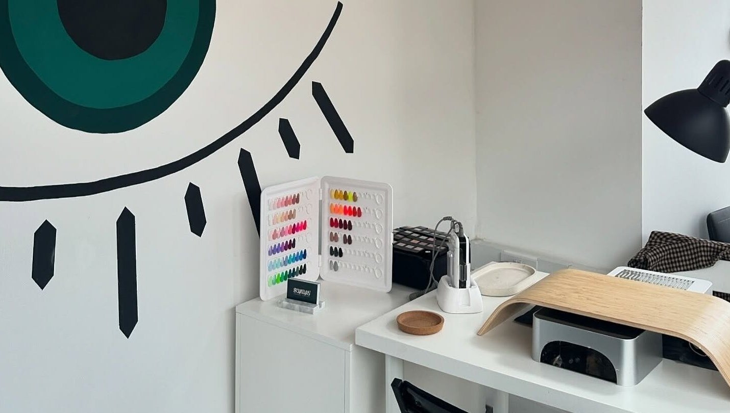 Nail studio at The Cure, Stockport, England, GB with a variety of nail polish colors and modern decor.