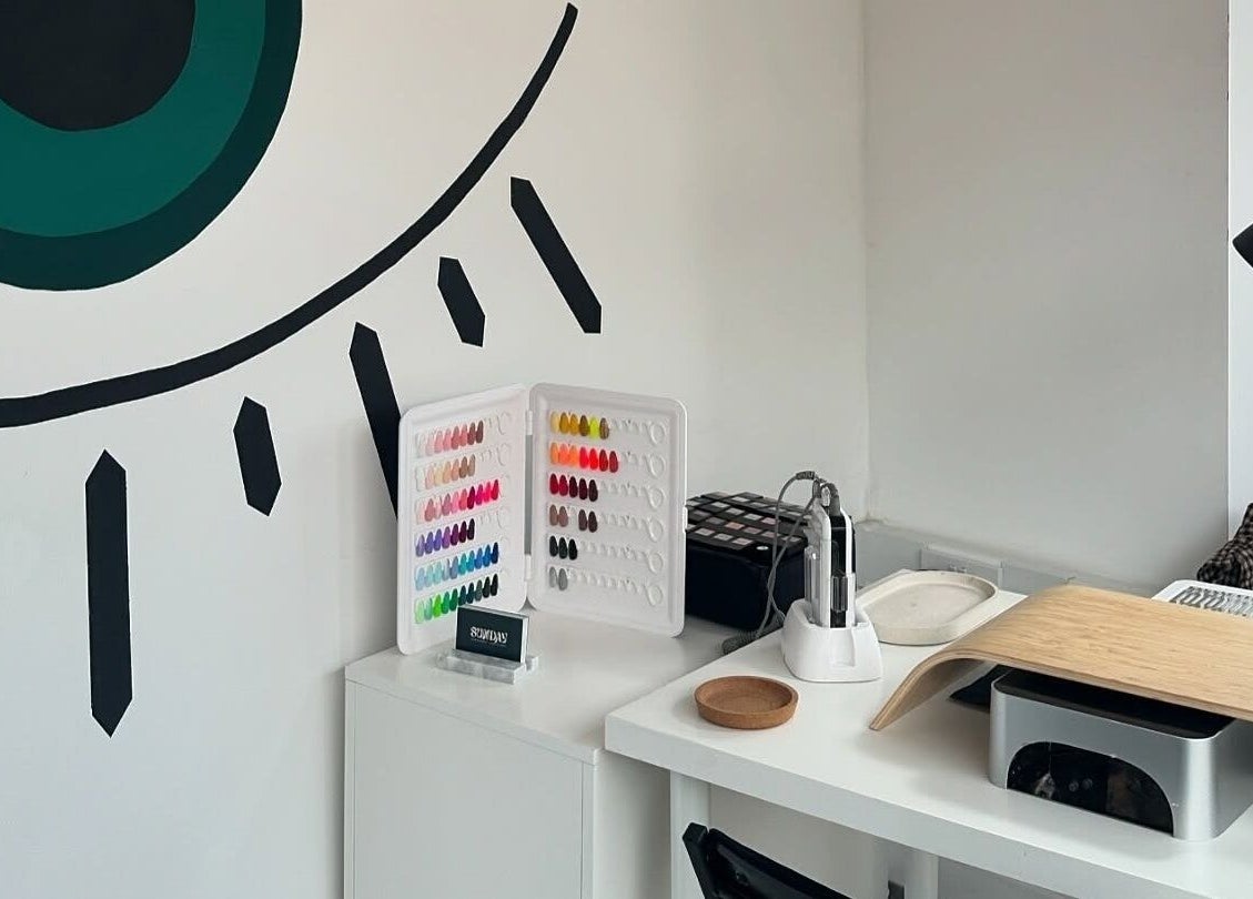 Nail studio at The Cure, Stockport, England, GB with a variety of nail polish colors and modern decor.