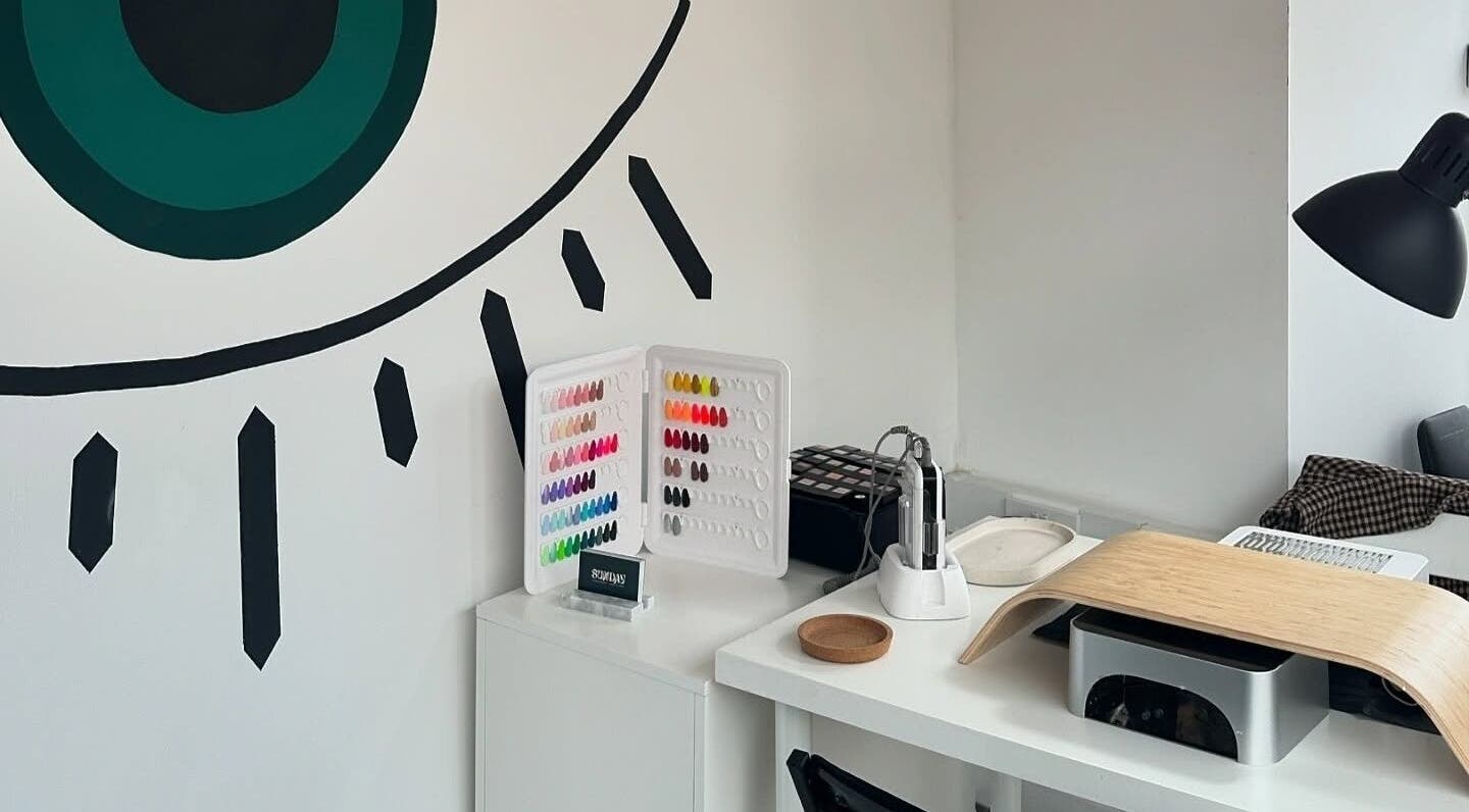 Nail studio at The Cure, Stockport, England, GB with a variety of nail polish colors and modern decor.