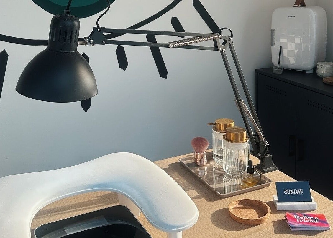 Elegant beauty station at The Cure in Stockport, England, GB with ambient lighting and beauty essentials.