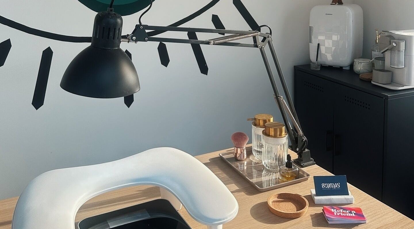 Elegant beauty station at The Cure in Stockport, England, GB with ambient lighting and beauty essentials.