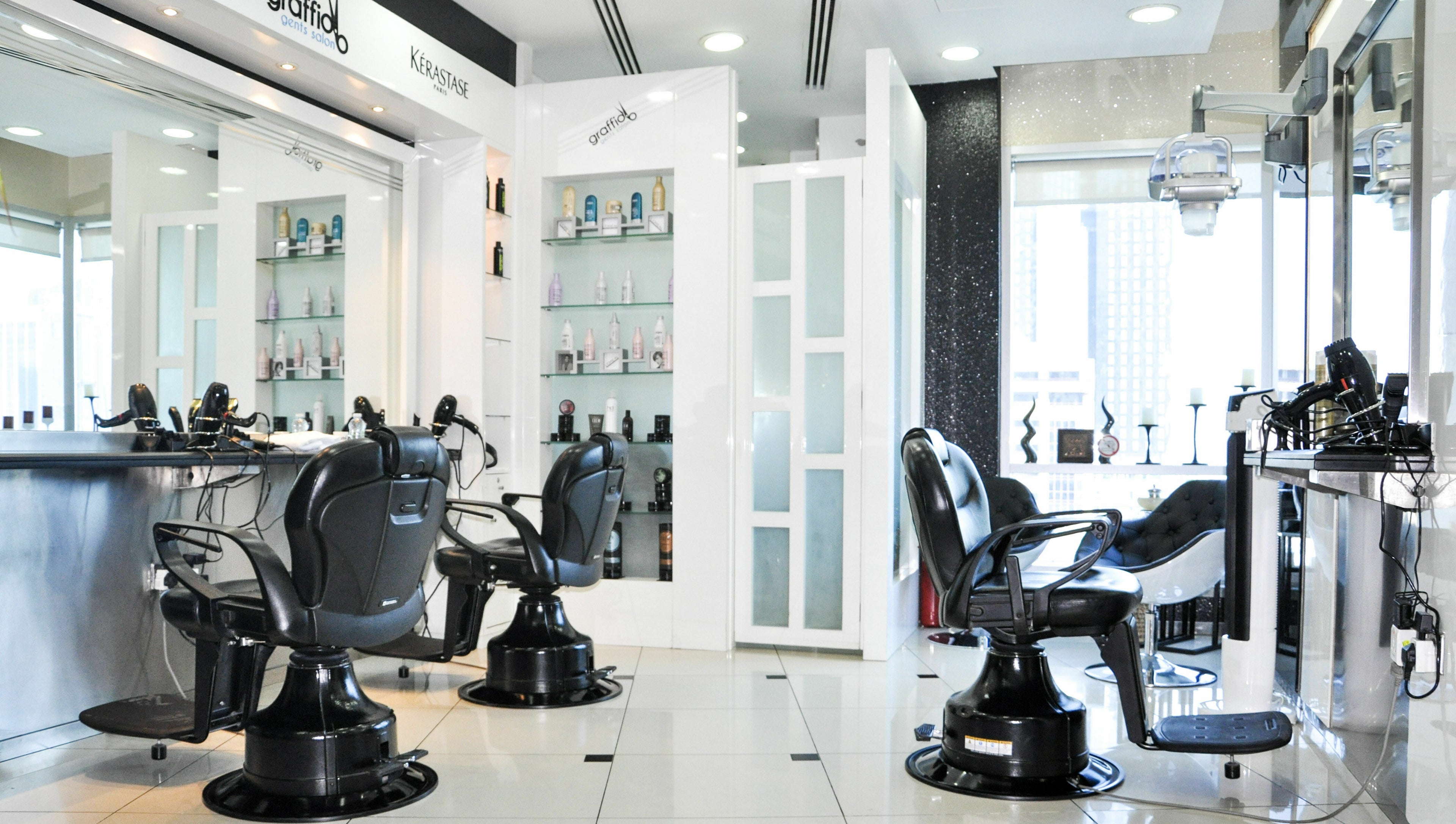 Modern interior of Graffio Gents Salon - Shangri-La Hotel in Dubai, AE, featuring sleek barber chairs and styling stations.