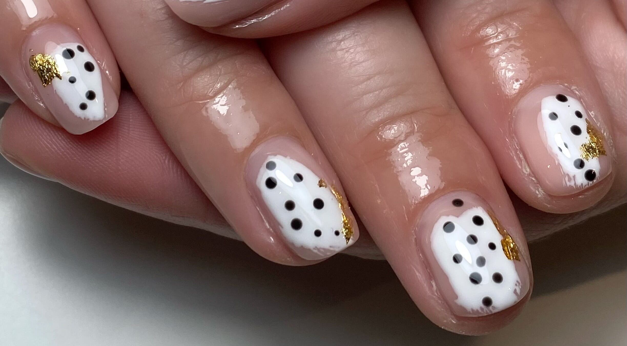 Polka dot nail art with gold accents at The Beauty Shack, Redcar, England, GB.