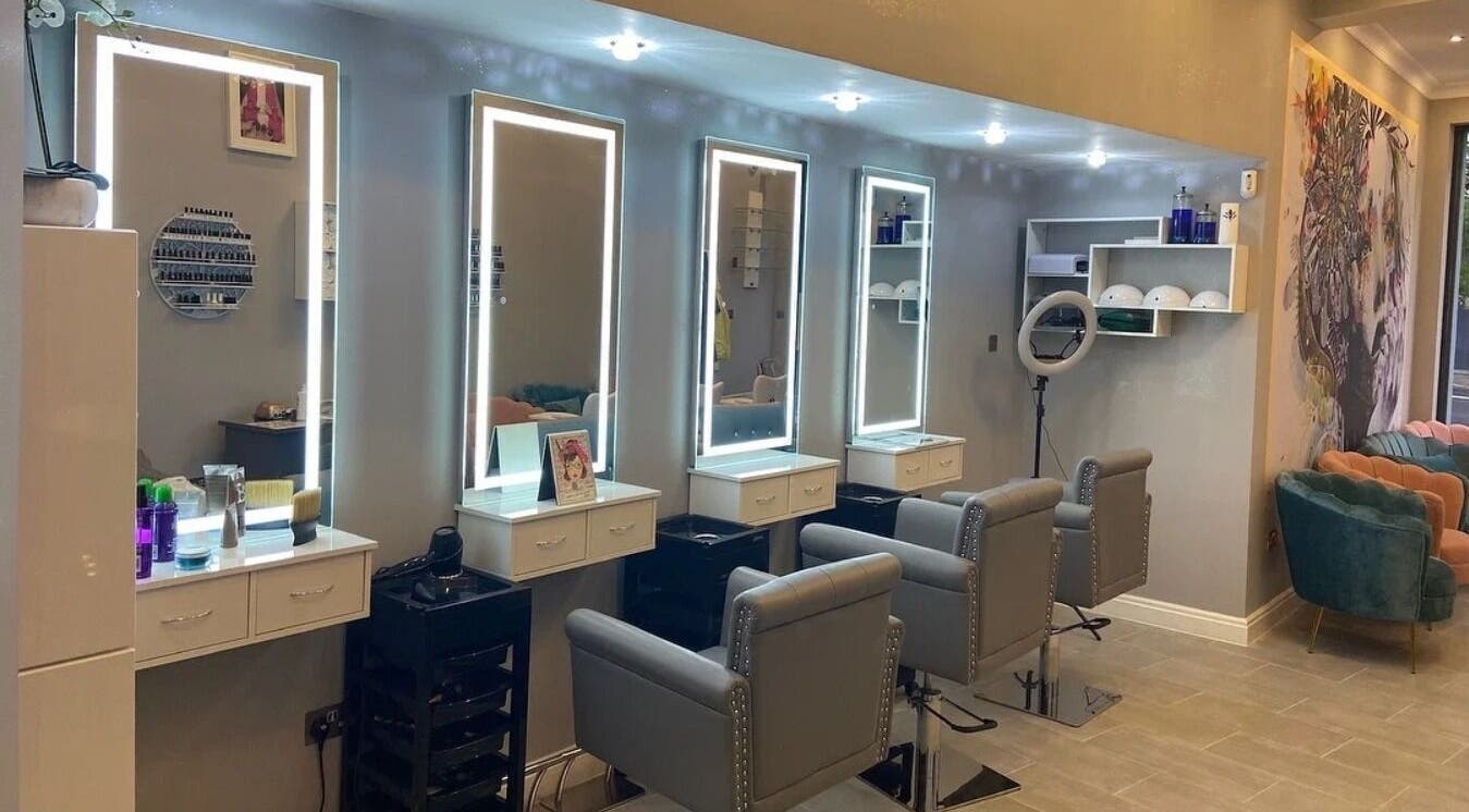 Elegant beauty salon interior at Soraias in London, England, GB with stylish chairs and illuminated mirrors.