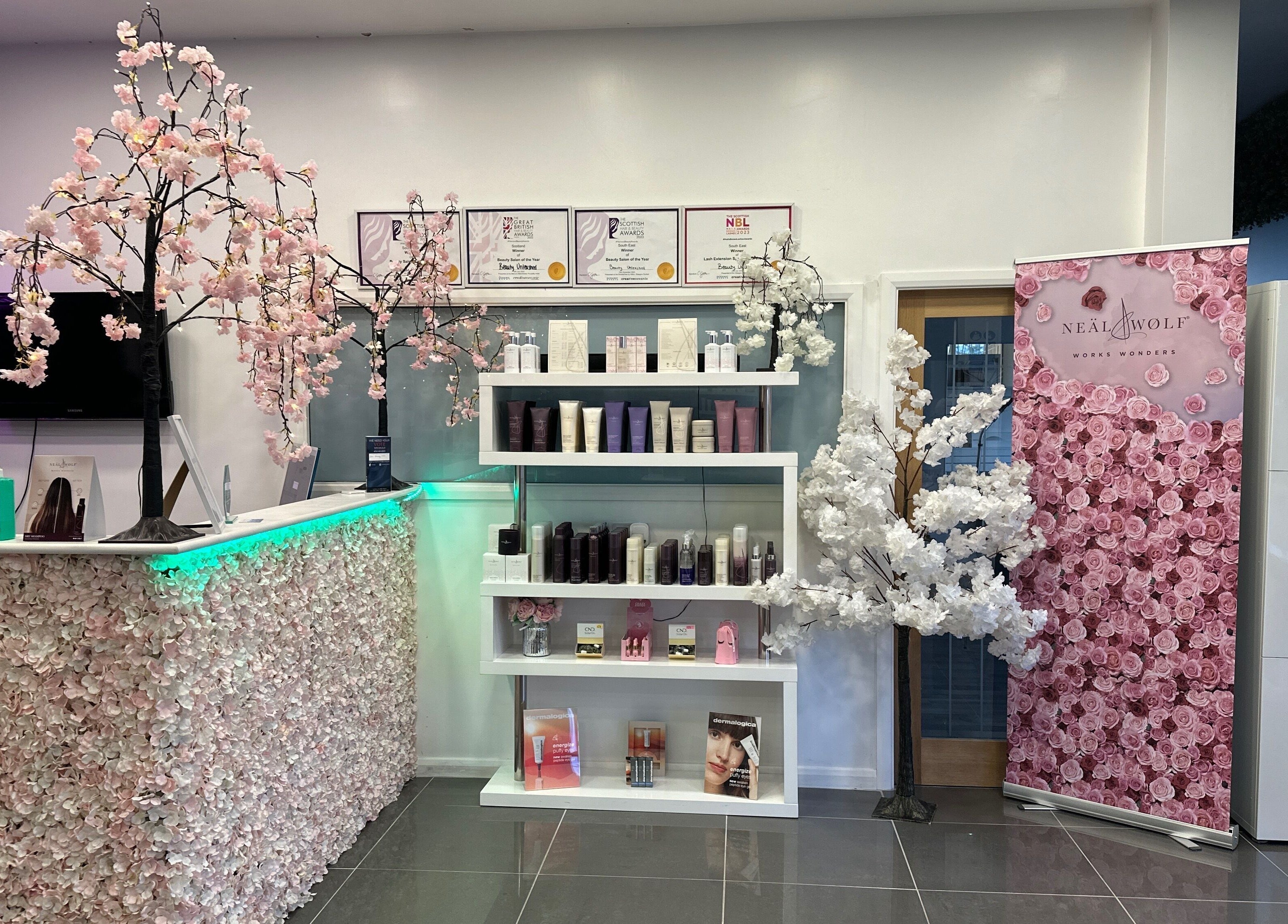 Reception area at Beauty Unleashed Multi Award Winning Hair and Beauty salon in Edinburgh, Scotland, GB, showcasing elegant cherry blossoms.