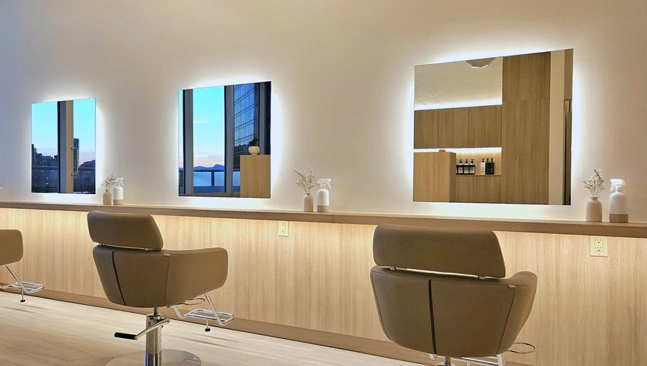 Interior of Forme Hair Salon & Head Spa in Vancouver, British Columbia, CA, featuring stylish salon chairs and mirrors.