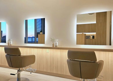 Interior of Forme Hair Salon & Head Spa in Vancouver, British Columbia, CA, featuring stylish salon chairs and mirrors.