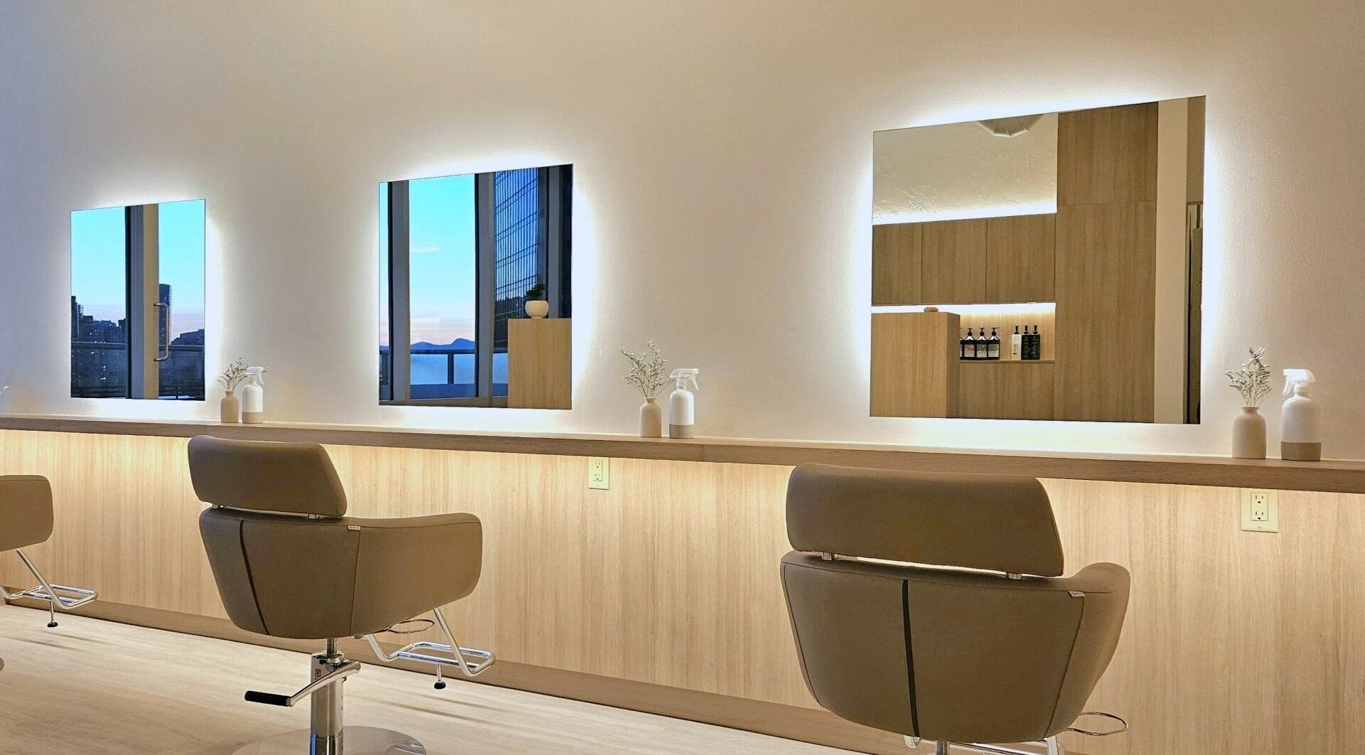 Interior of Forme Hair Salon & Head Spa in Vancouver, British Columbia, CA, featuring stylish salon chairs and mirrors.
