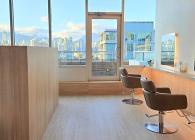 Modern interior of Forme Hair Salon & Head Spa, Vancouver, British Columbia, CA with city skyline view.