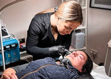 Expert performing beauty treatment at Naked Glow Clinic, Hartland, England, GB.
