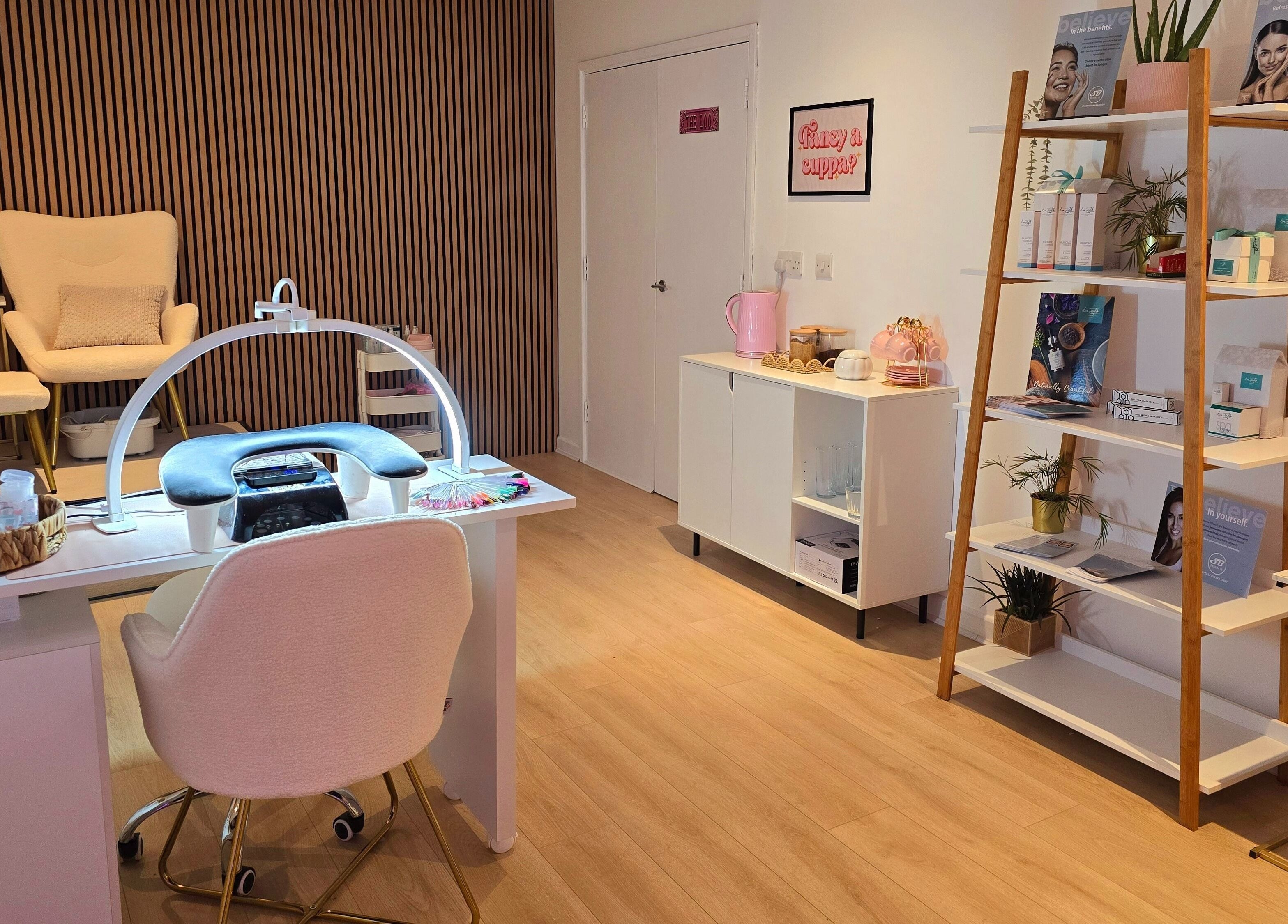 Elegant interior at Naked Glow Clinic, Hartland, England, GB with manicure table and cozy seating.