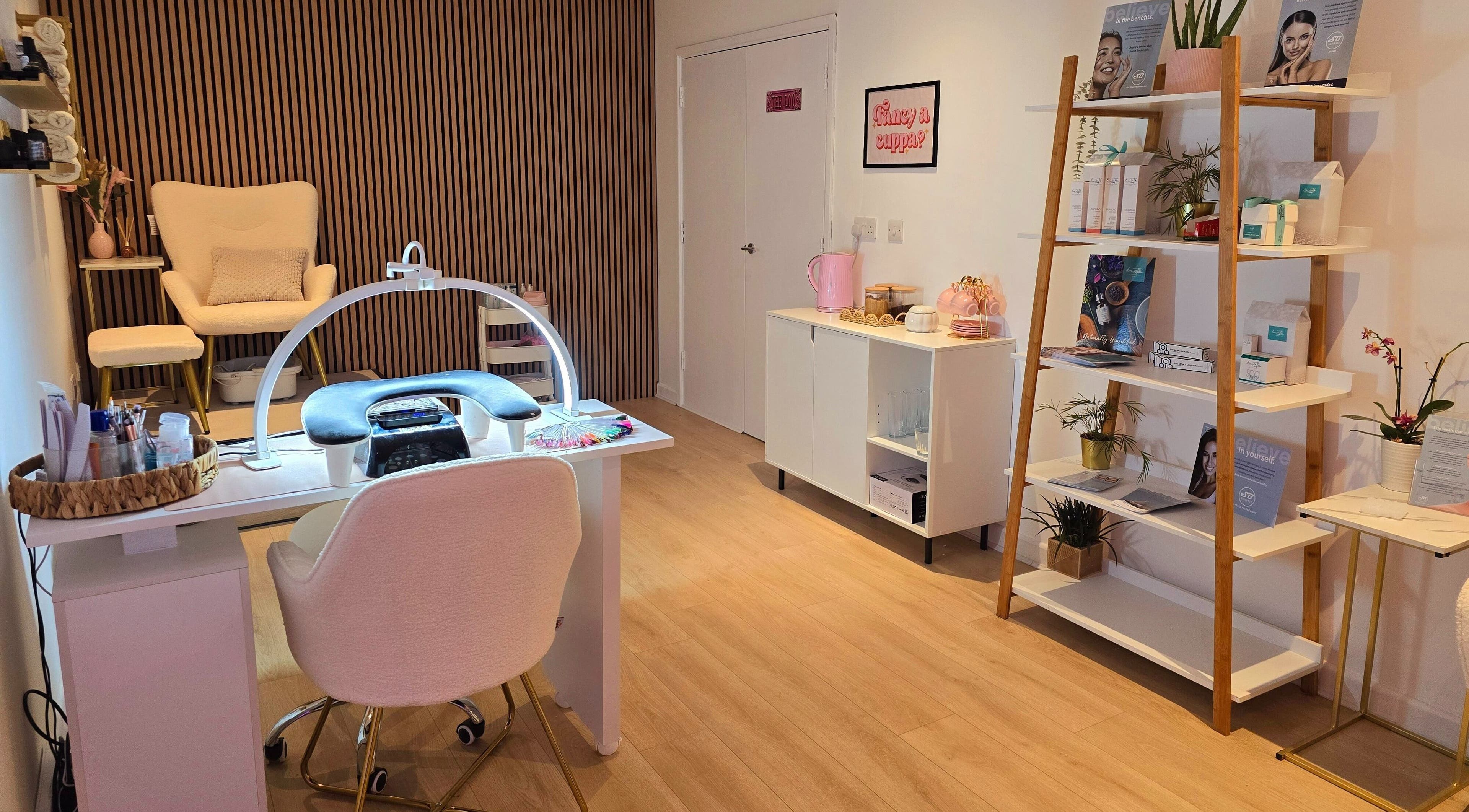 Elegant interior at Naked Glow Clinic, Hartland, England, GB with manicure table and cozy seating.