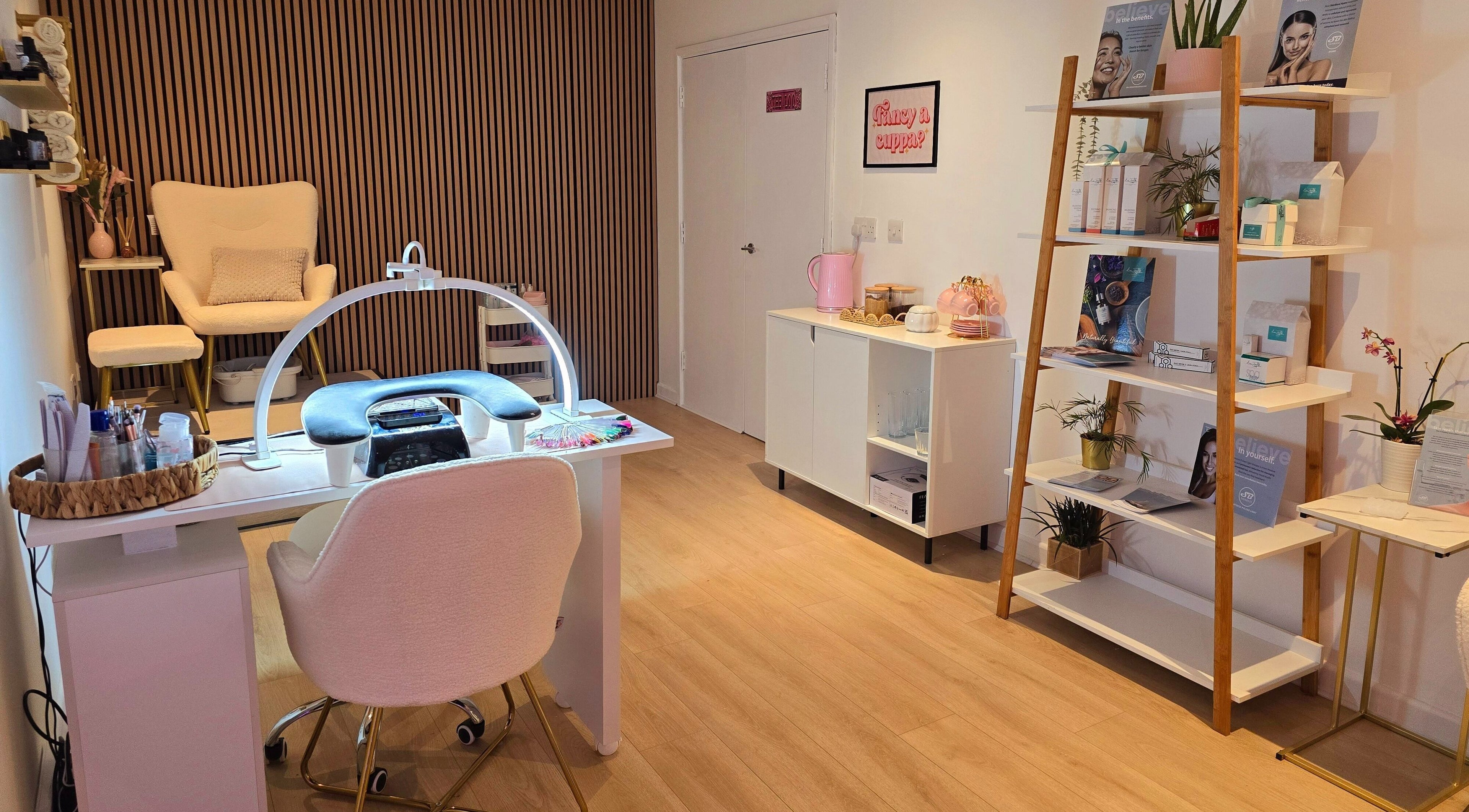 Elegant interior at Naked Glow Clinic, Hartland, England, GB with manicure table and cozy seating.