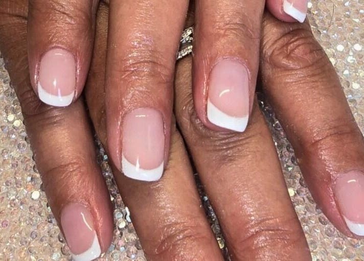 Elegant French manicure at Naked Glow Clinic, Hartland, England, GB showcasing pristine nail art.