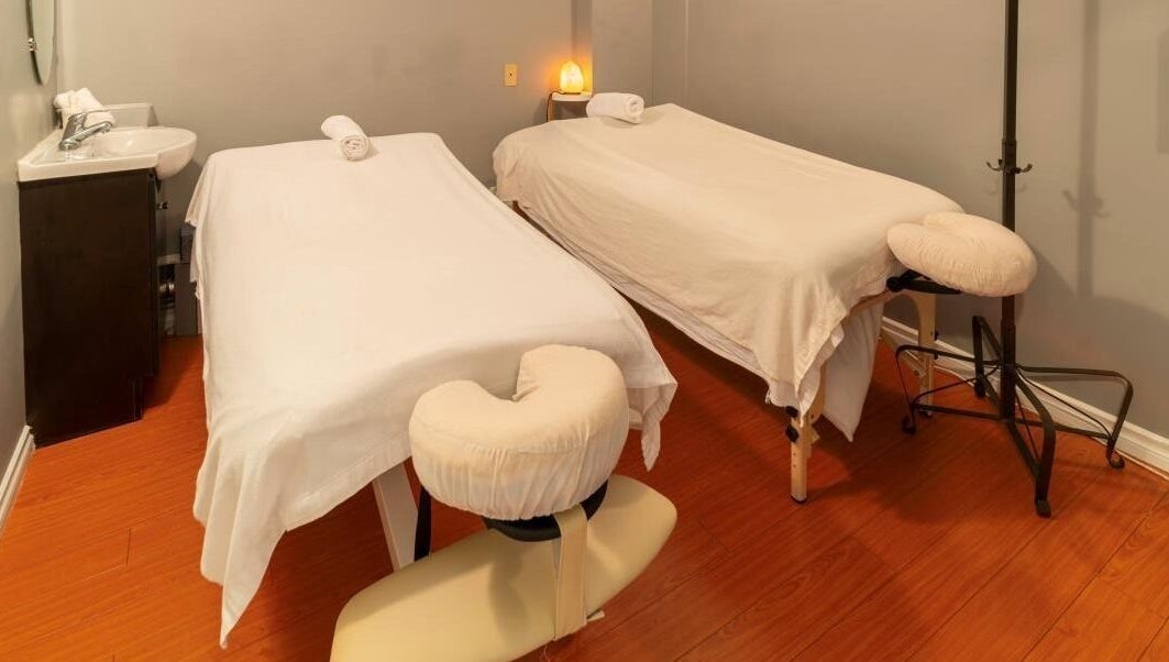 Relaxing massage room at Comfy Spa, Vancouver, British Columbia, CA, featuring two massage tables.