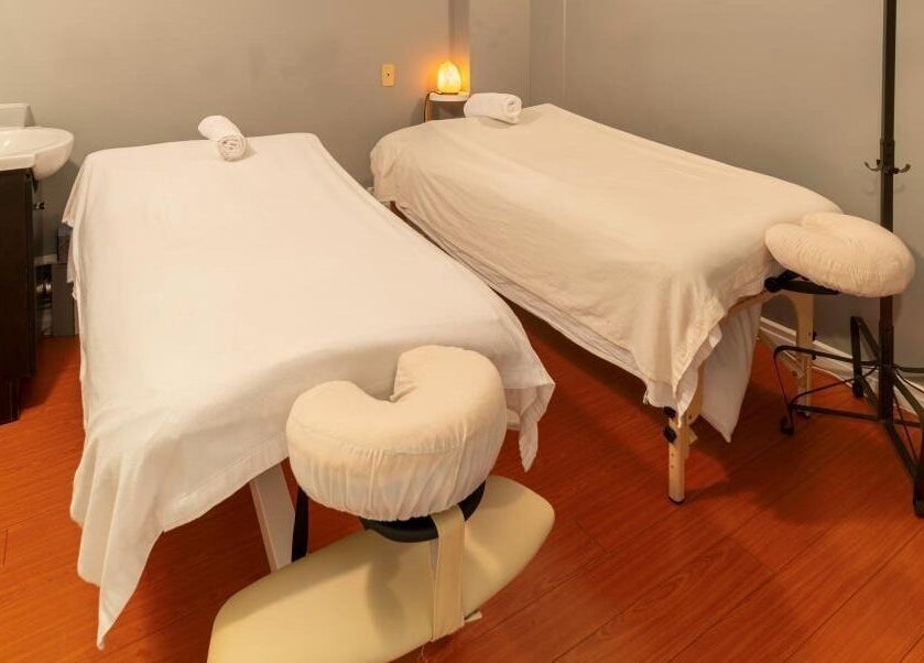 Relaxing massage room at Comfy Spa, Vancouver, British Columbia, CA, featuring two massage tables.