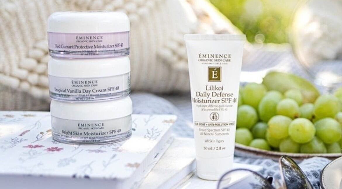 Skincare products at Brows & Skin by Julie B, Medicine Hat, Alberta, CA with fresh grapes and serene setting.