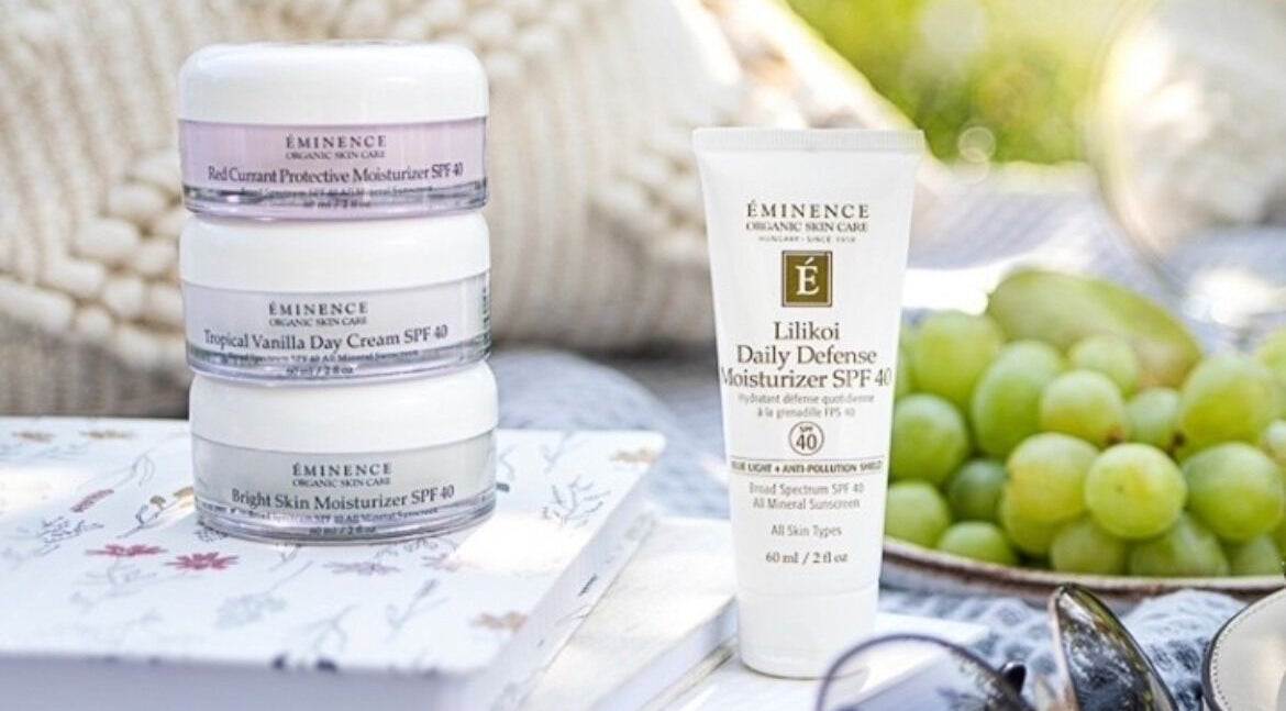 Skincare products at Brows & Skin by Julie B, Medicine Hat, Alberta, CA with fresh grapes and serene setting.