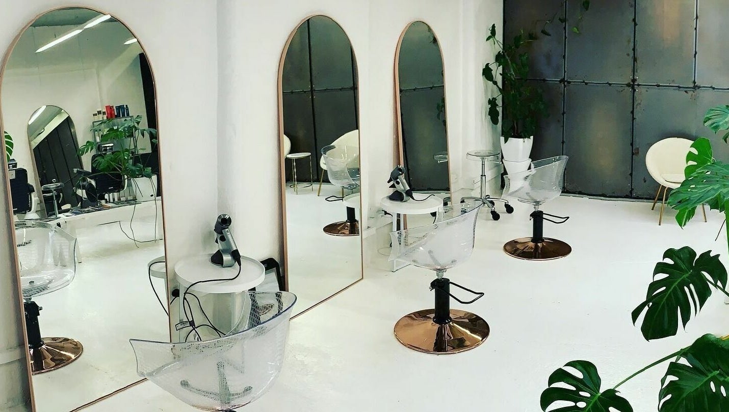 Modern salon interior at Worksense Haircutters in Melbourne, VIC, AU with sleek chairs and large mirrors.