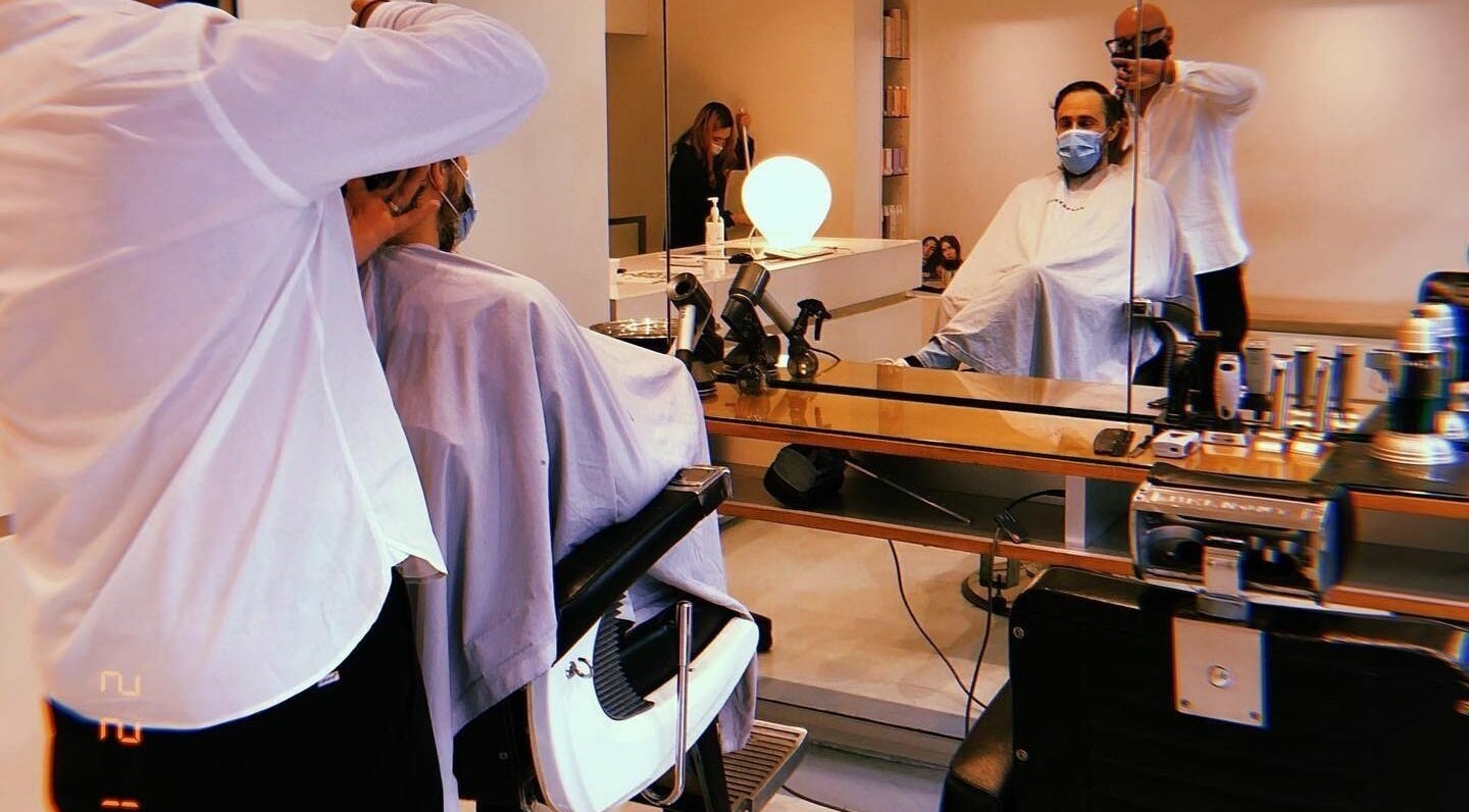 Stylish haircut in progress at Worksense Haircutters, Melbourne, VIC, AU. Sophisticated interior with mirror.