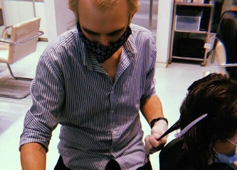 Hair stylist at Worksense Haircutters, Melbourne VIC performing a haircut with precision.