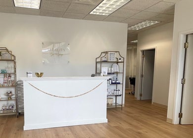 Reception area of Vitality Spa and Lounge, Bloomsburg, Pennsylvania, US, with elegant shelving and decor.