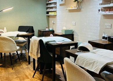 Relaxing treatment space at Chapel Beauty By Lucia, Harrogate, England, GB with cozy chairs and wooden decor.