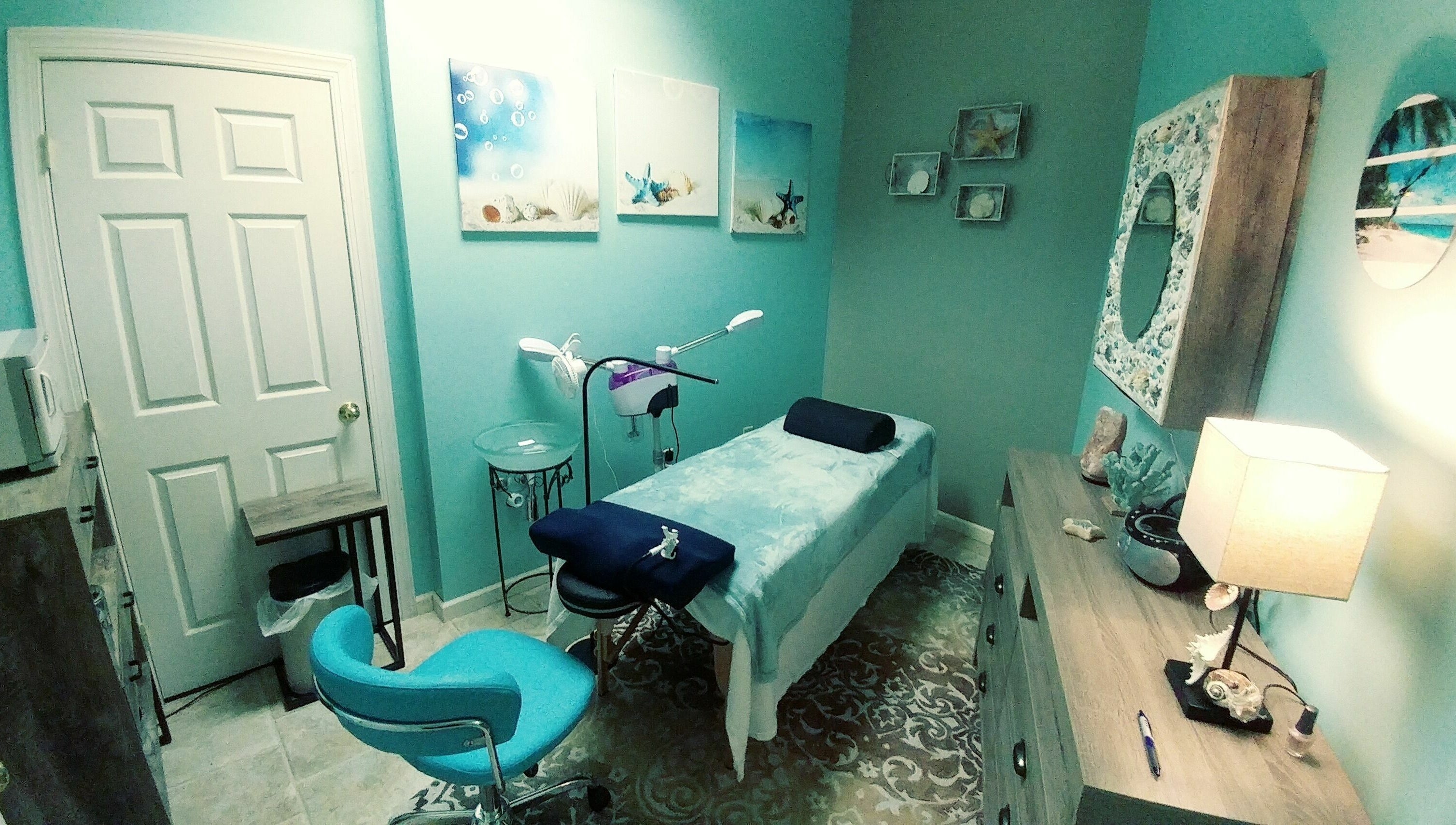 Relaxing spa room at Tropical Escape, Sherrill, New York, US, featuring a treatment table and calming decor.