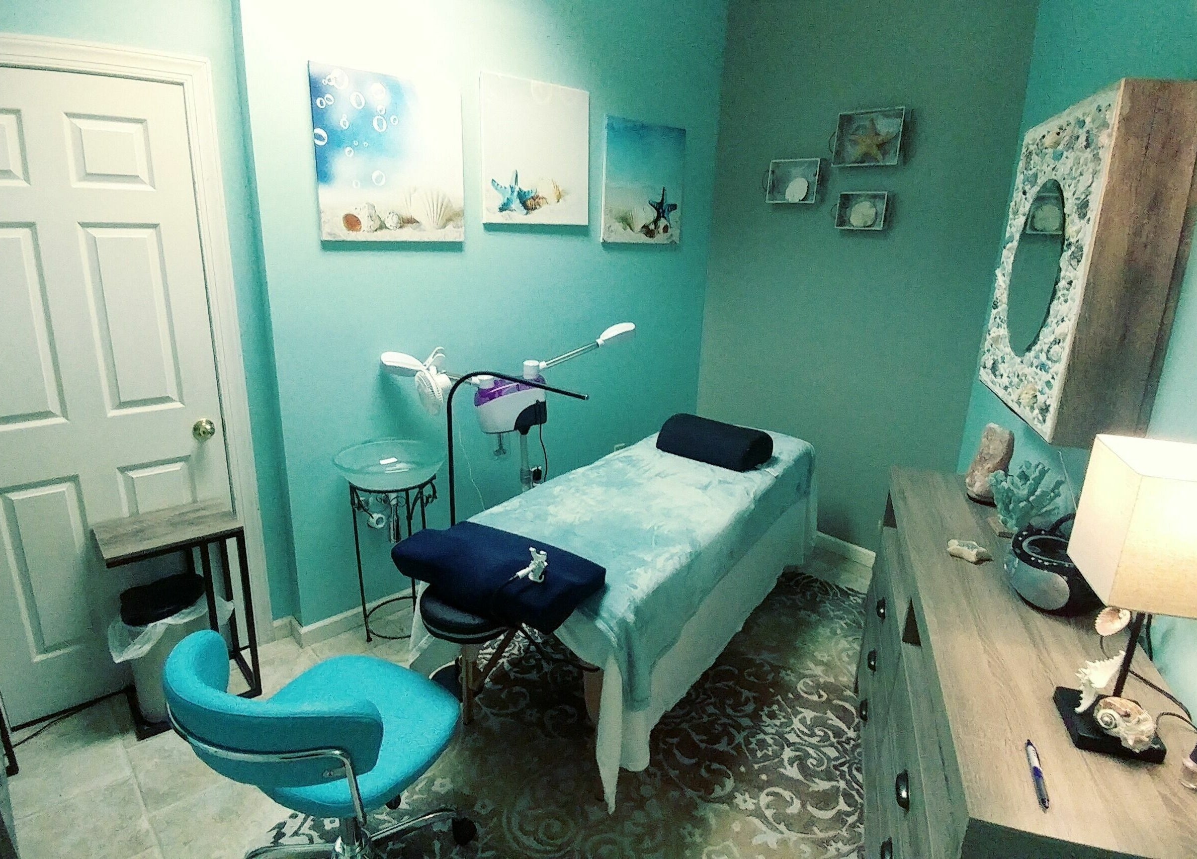 Relaxing spa room at Tropical Escape, Sherrill, New York, US, featuring a treatment table and calming decor.