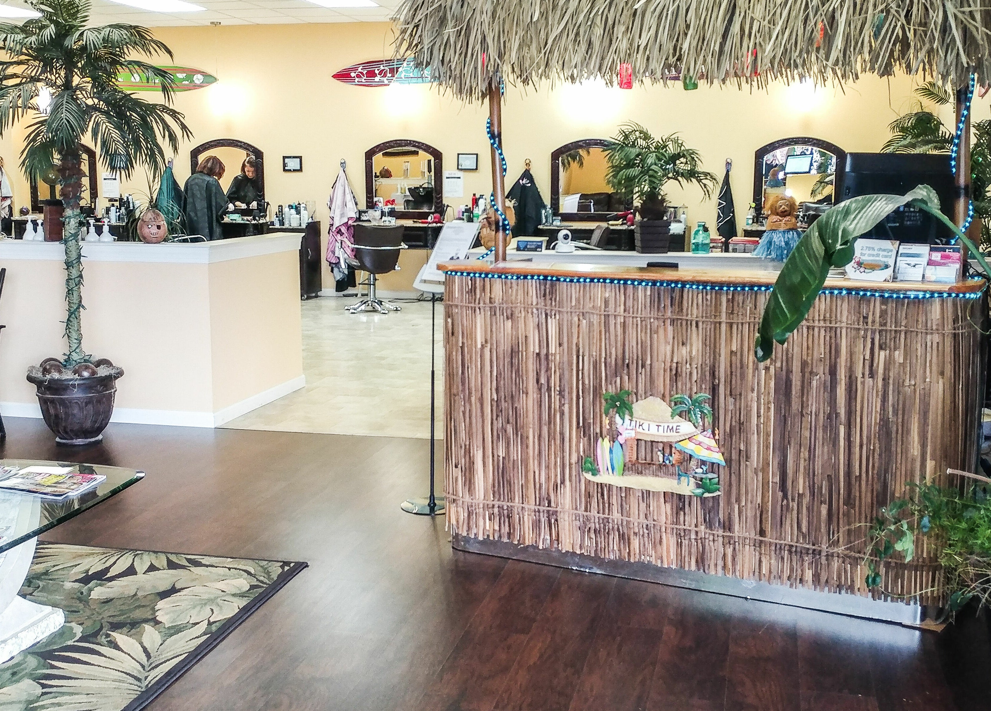 Relaxing interior of Tropical Escape, a beauty salon in Sherrill, New York, US, featuring tropical decor and lush plants.