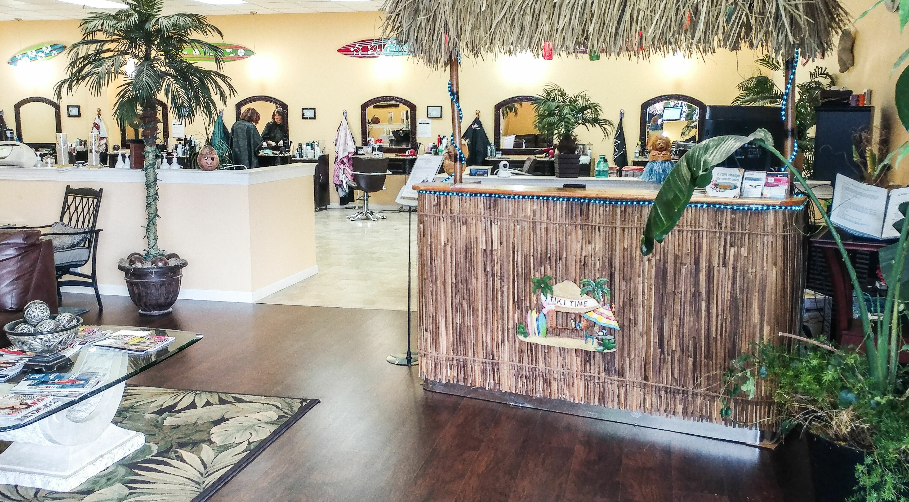 Relaxing interior of Tropical Escape, a beauty salon in Sherrill, New York, US, featuring tropical decor and lush plants.