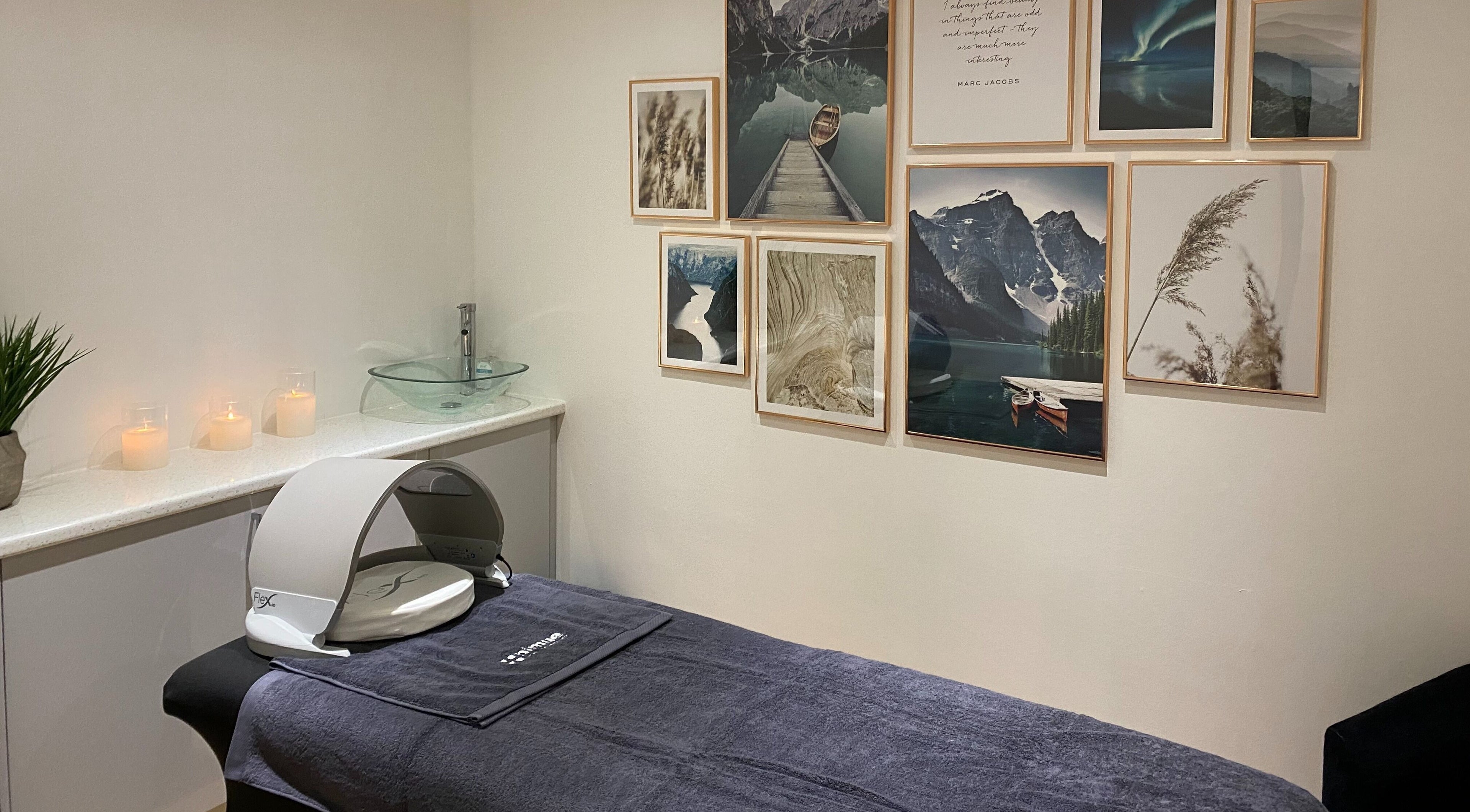 Relaxing treatment room at Alpha Beauty in Ilchester, England, GB, featuring candles and calming wall art.