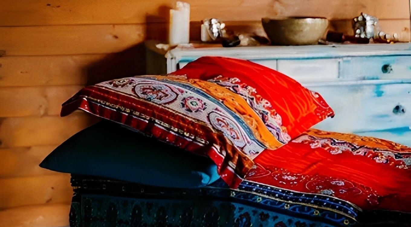 Vibrant cushions on a wooden bench at Touching Lives, Hampton, England, GB. Perfect for relaxation.