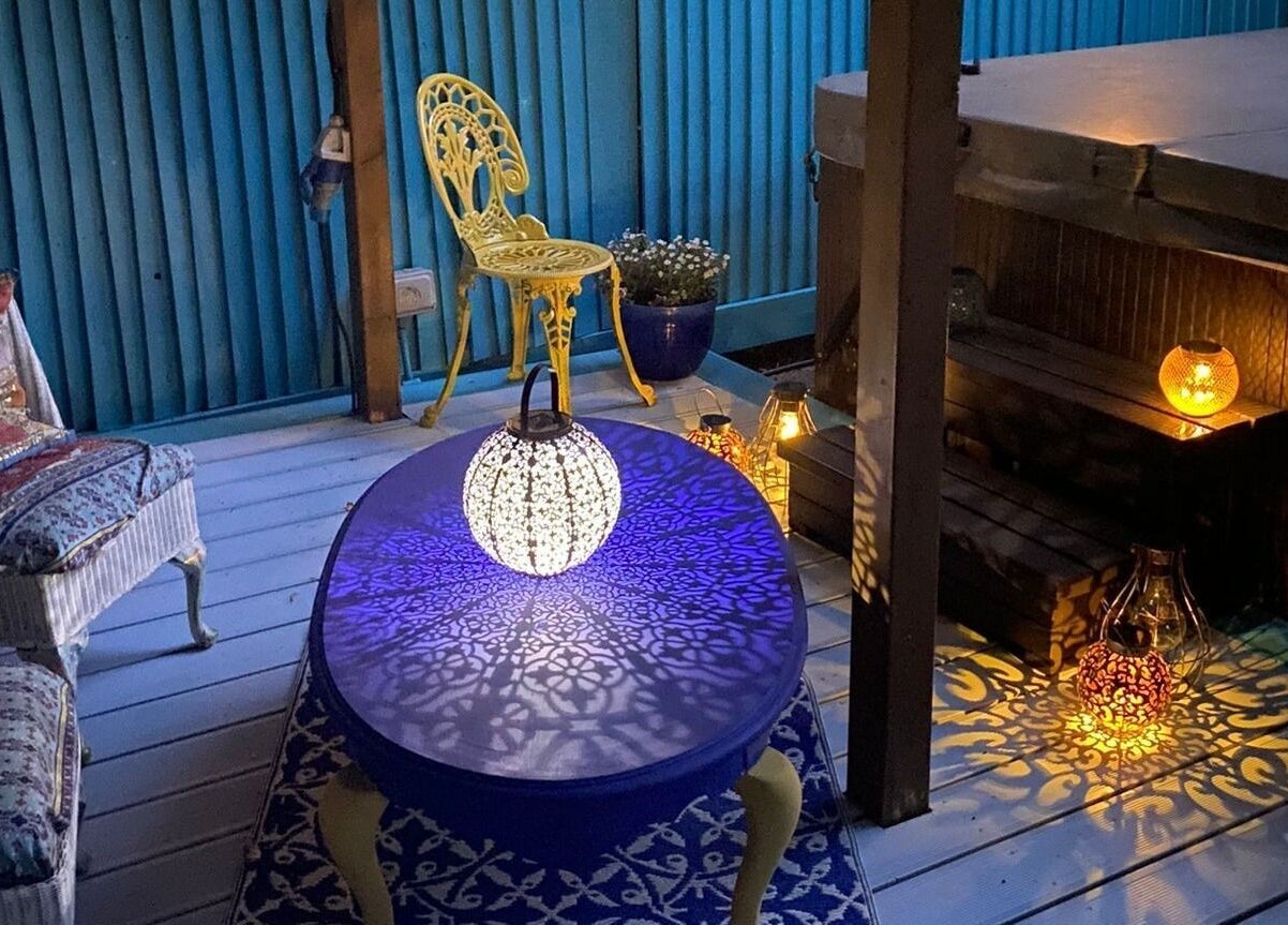 Ambient lit patio at Touching Lives, Hampton, England, GB with intricate decor and soft lighting.