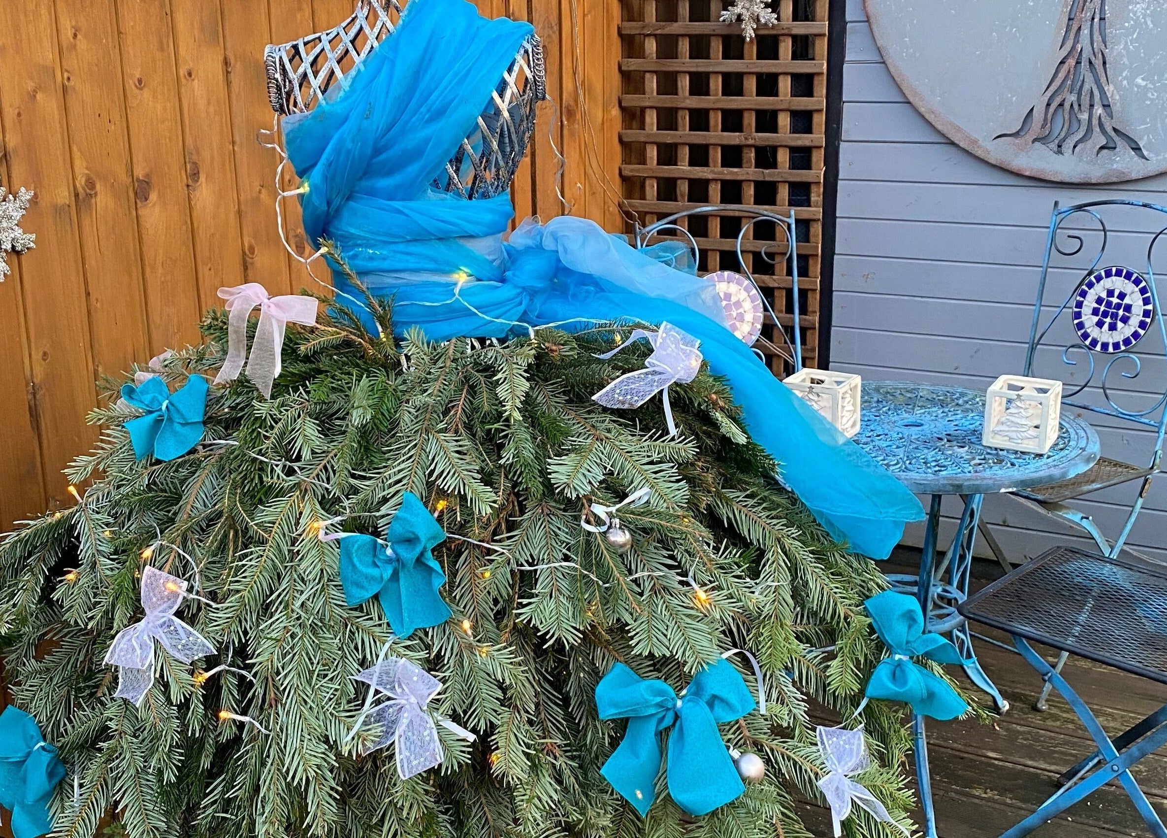 Whimsical decoration at Touching Lives, Hampton, England, GB with blue drapery and evergreen bows.