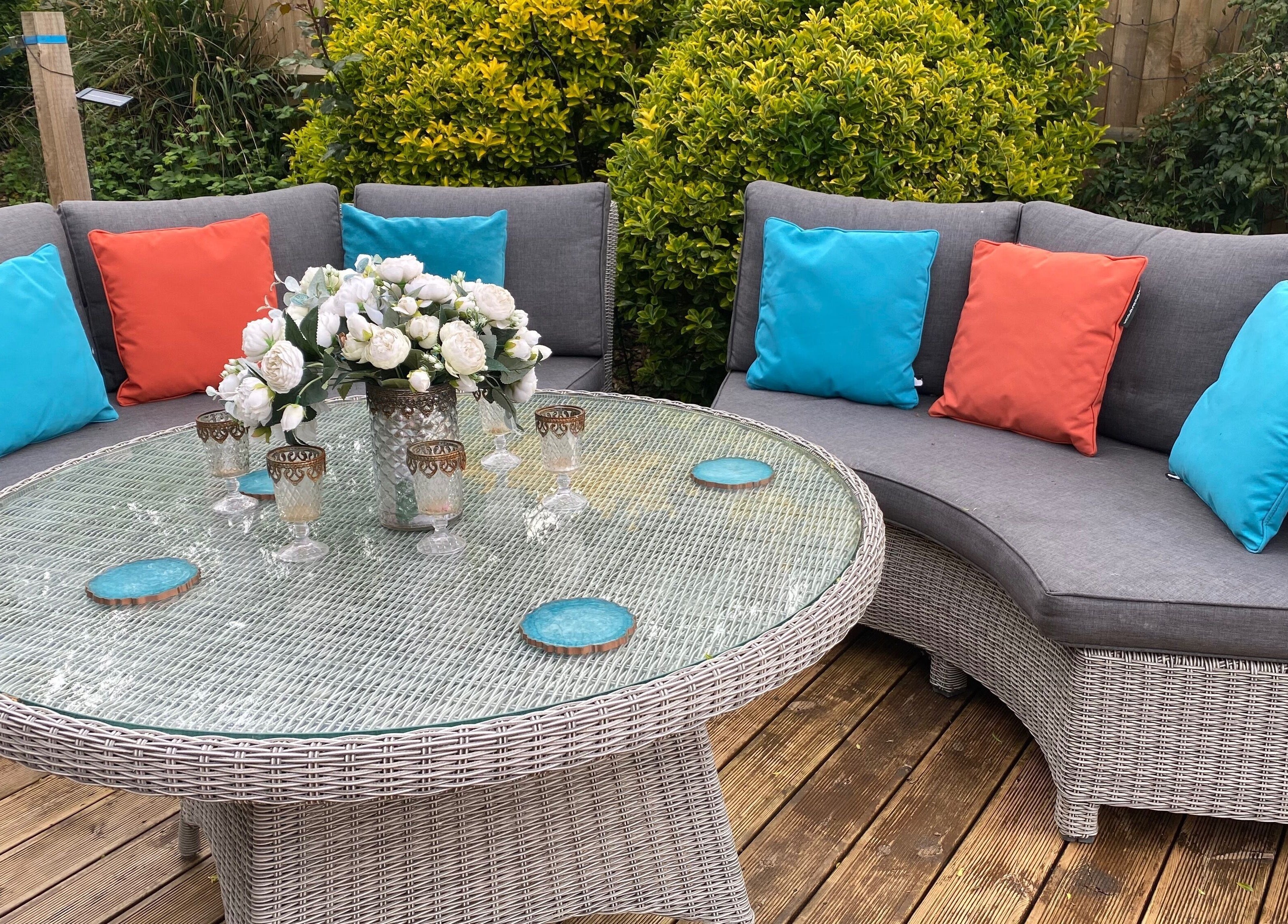 Touching Lives' cozy outdoor seating with colorful pillows in Hampton, England, GB.