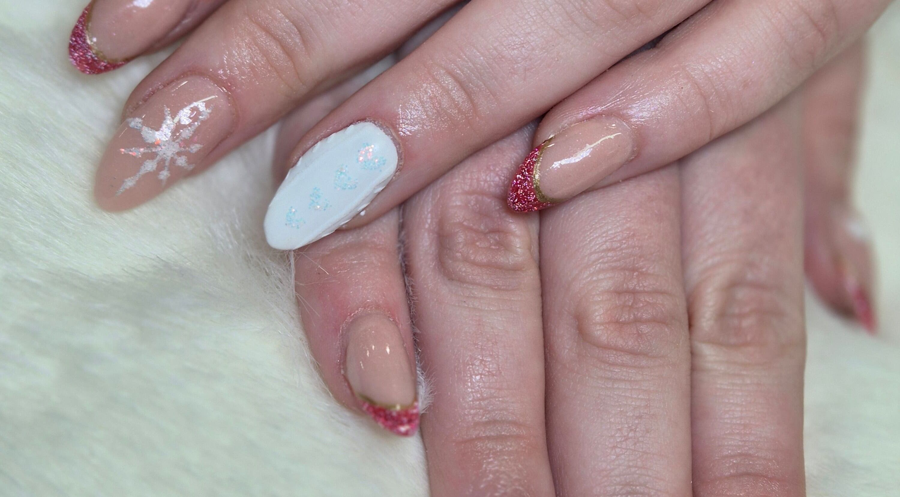 Exquisite nail art at Desired Beauty, St Helens, England, GB showcasing intricate designs with shimmering accents.