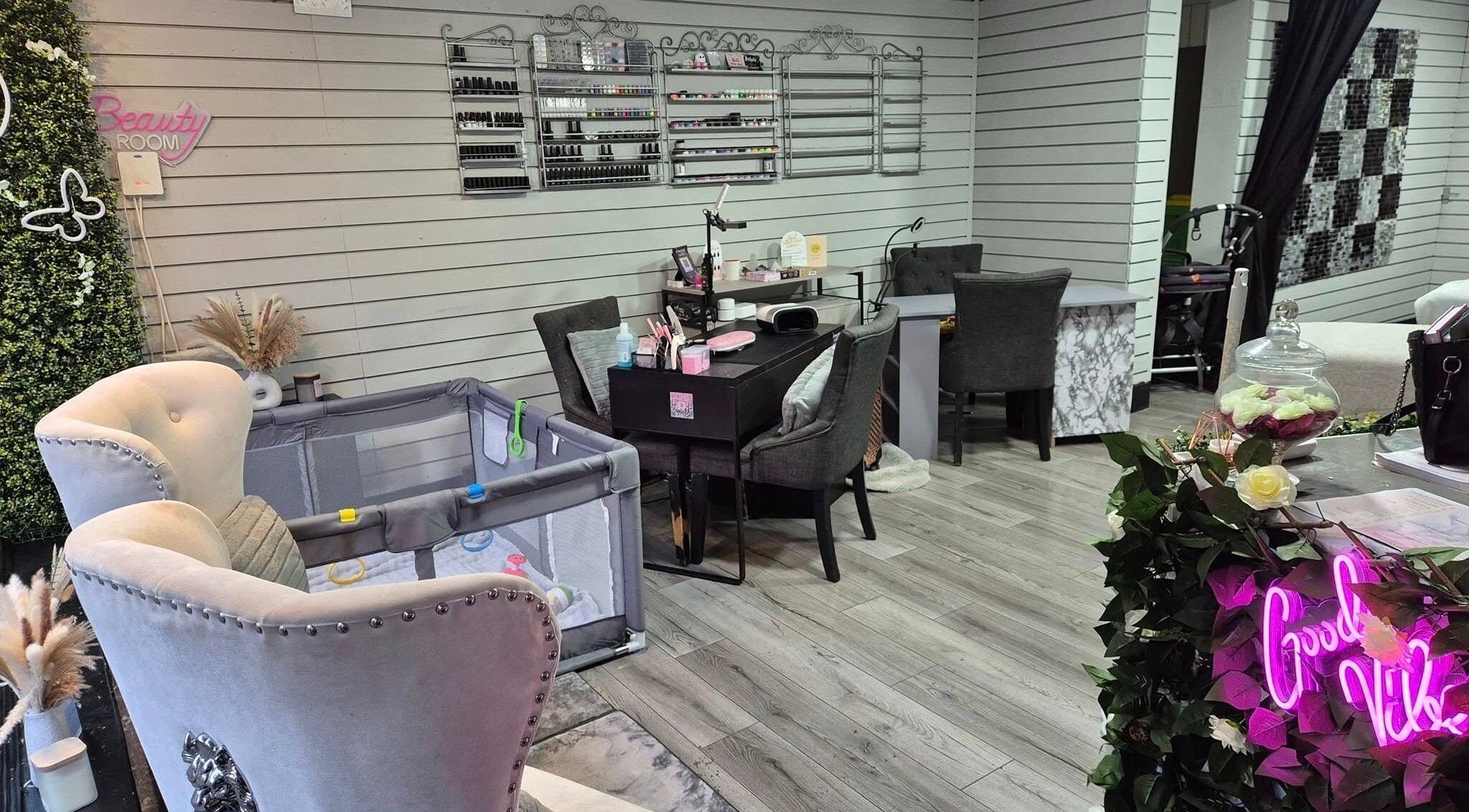 Interior of Desired Beauty in St Helens, England, GB featuring plush chairs and nail stations.